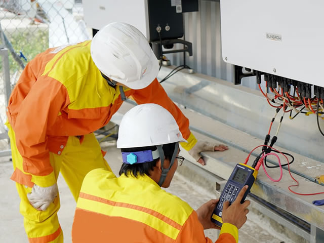 Workers checking electrical installation